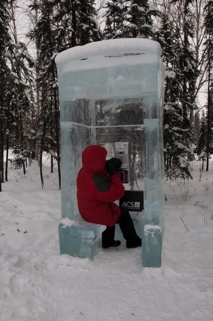 A woman in a telephone booth made of ice in Fiarbanks Ice Museum, Alaska. USA. [Photo of the day - September 2011]