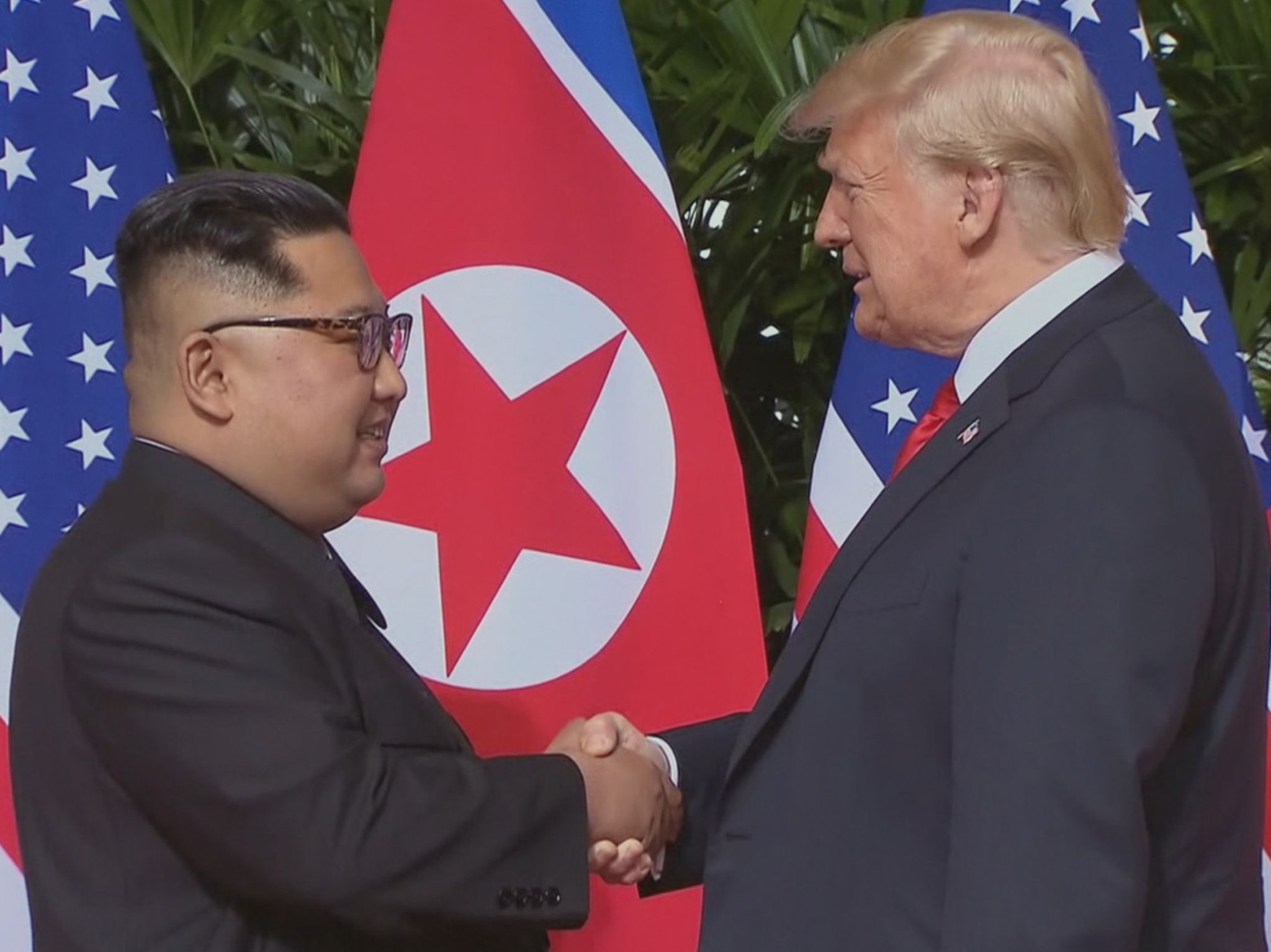 President Donald Trump and North Korean leader Kim Jong-un shake hands at the Singapore Summit... [Photo of the day - February 2021]