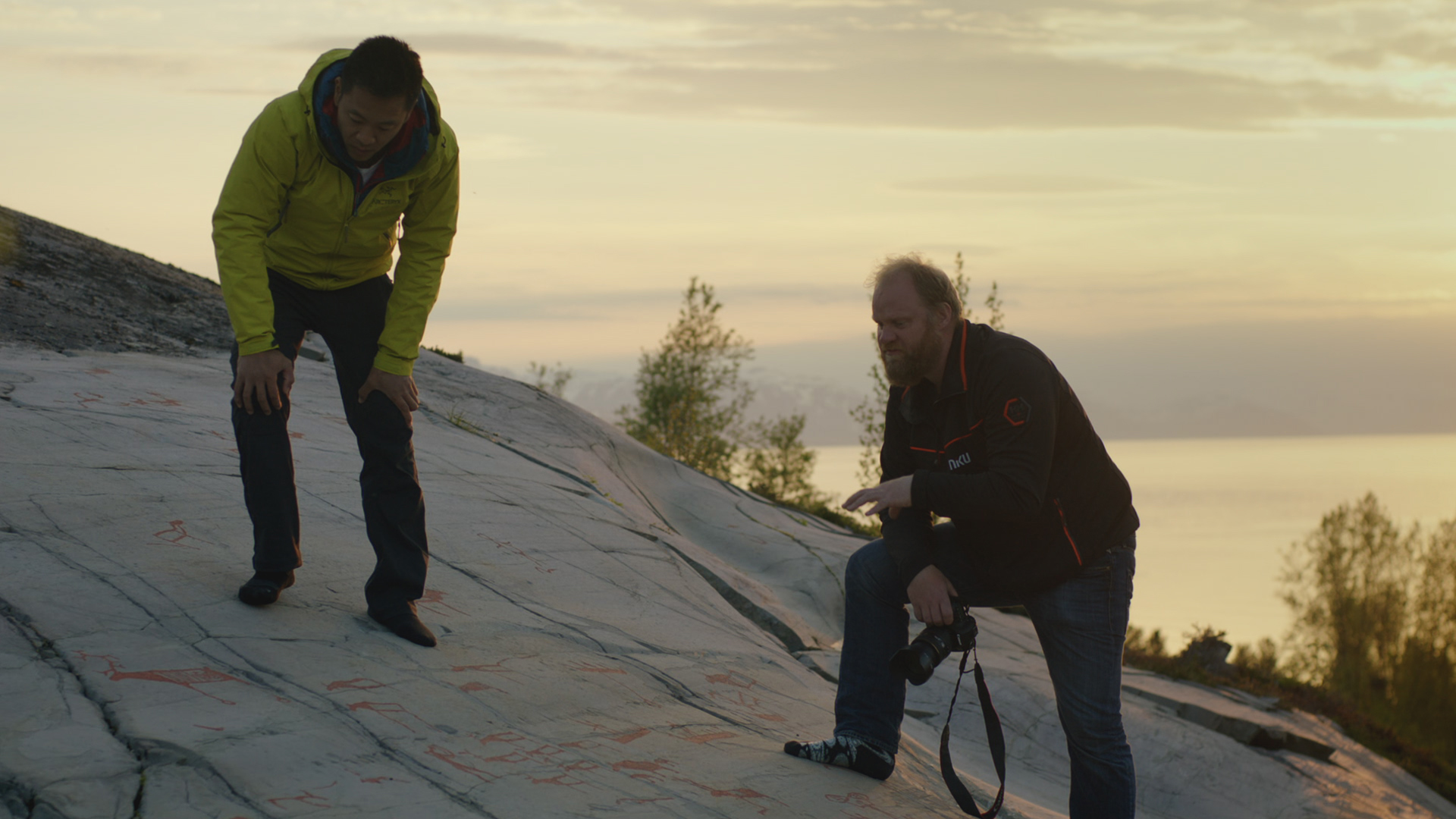 Albert Lin (L) and Jan look at rock art in Norway. This is from Ancient worlds revealed with... [Photo of the day - April 2022]