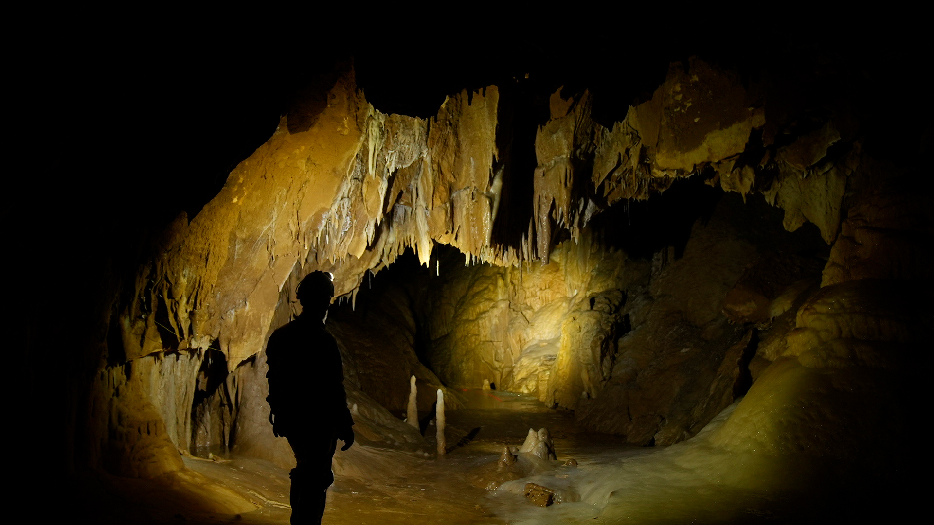 A Cheve caving team member lights up the cavern in front of him deep beneath the cave's... [Photo of the day - June 2022]