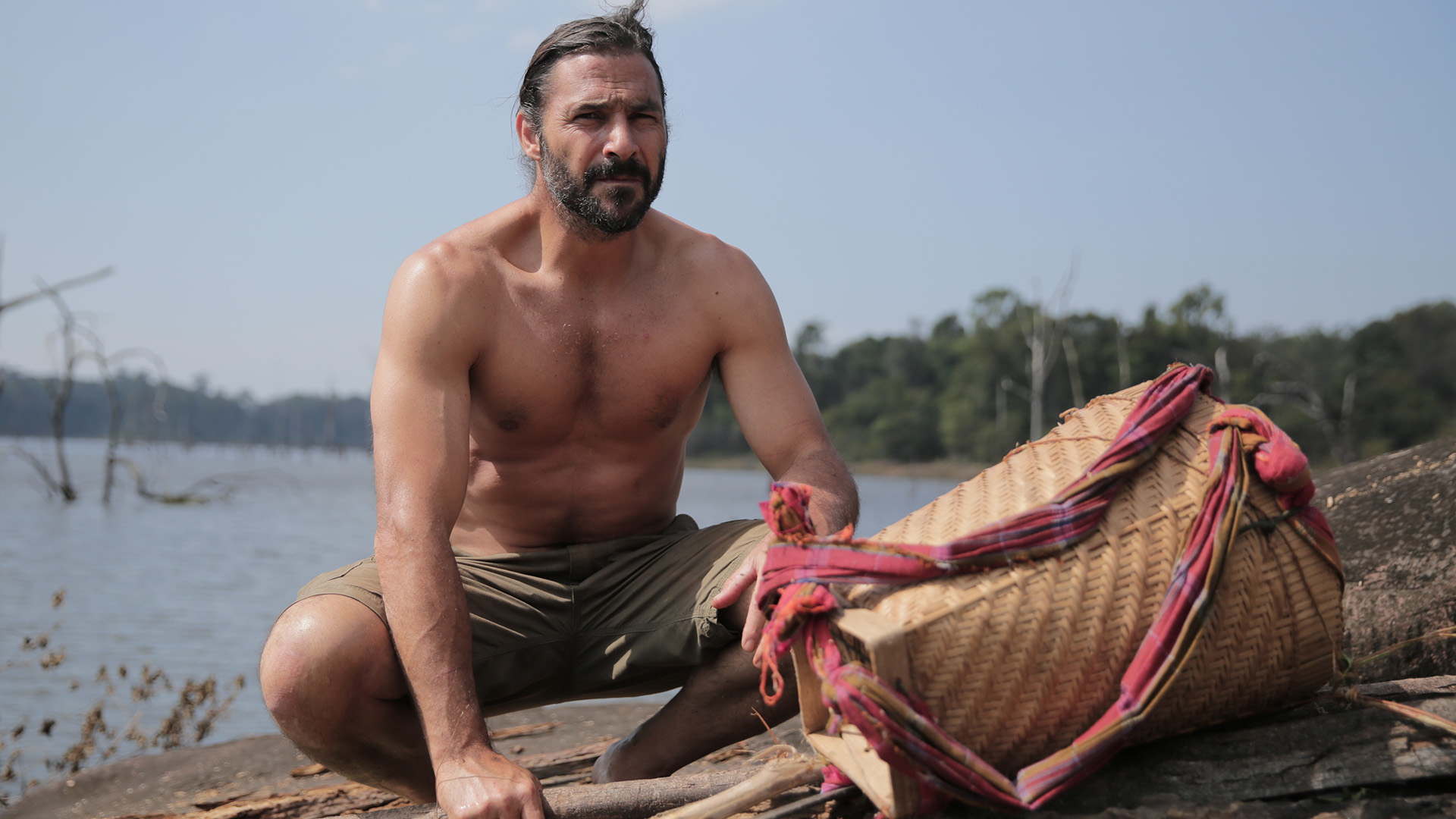 Hazen crouched beside basket on the banks of the Mekong. This is from Primal Survivor: Ultimate... [Photo of the day - August 2022]