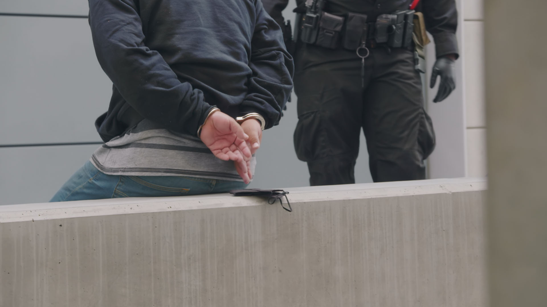 Officer with man in handcuffs. This is from TO CATCH A SMUGLER. [Photo of the day - December 2022]