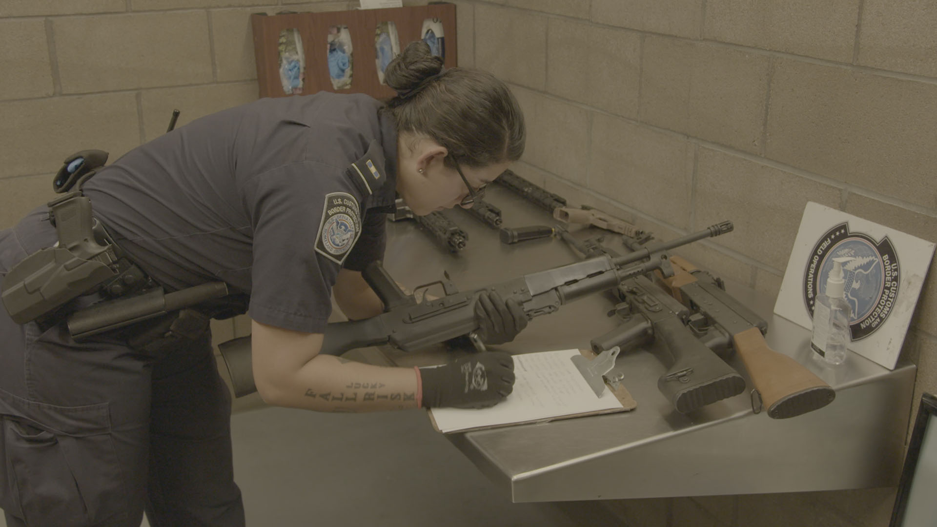 A CBP Officer logs guns that were seized. This is from TO CATCH A SMUGLER. [Photo of the day - December 2022]