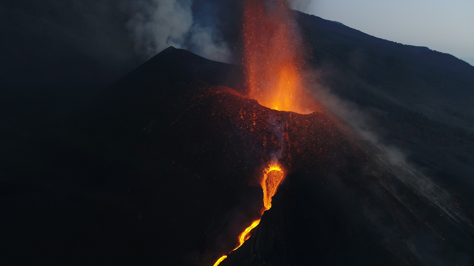 A view of a volcano crater erupting with lava flowing down the mountain. This is from Canary... [Photo of the day - January 2023]