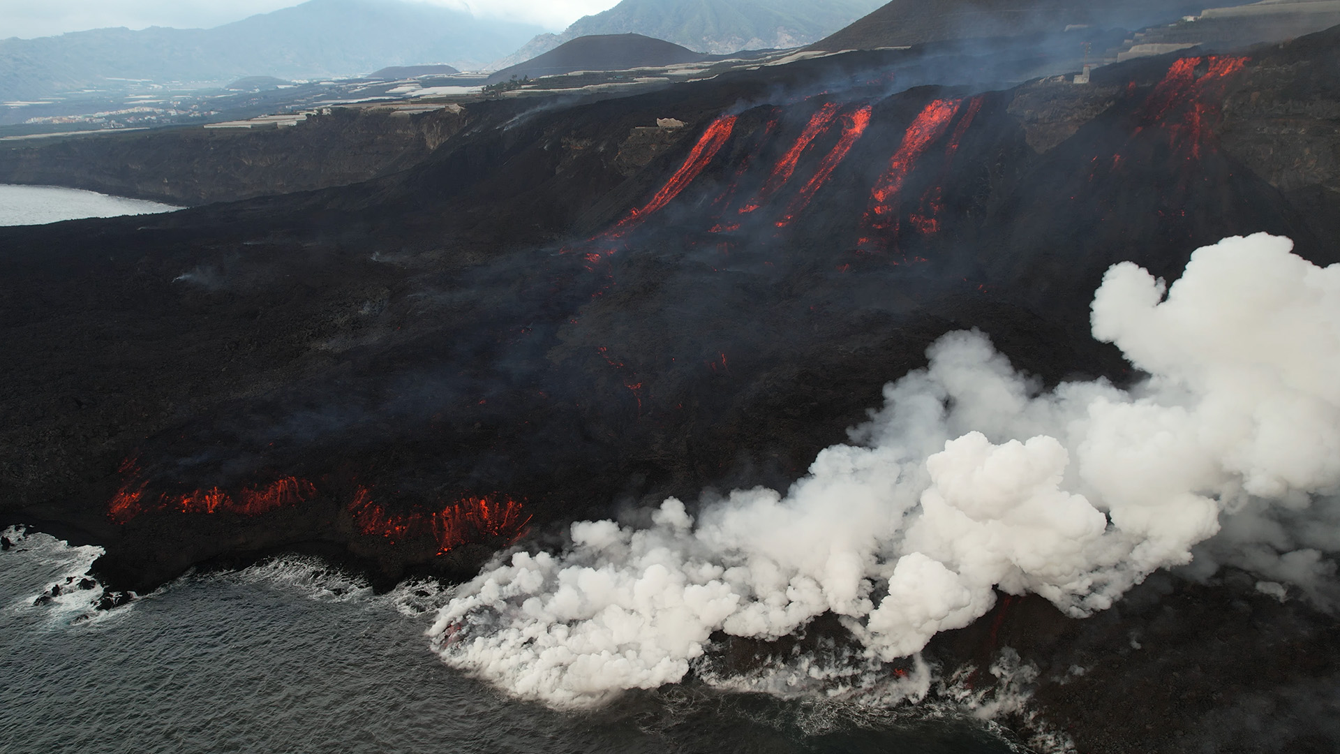 Rivers of lava fall into the sea. This is from Canary Islands: Born of Fire. [Photo of the day - January 2023]