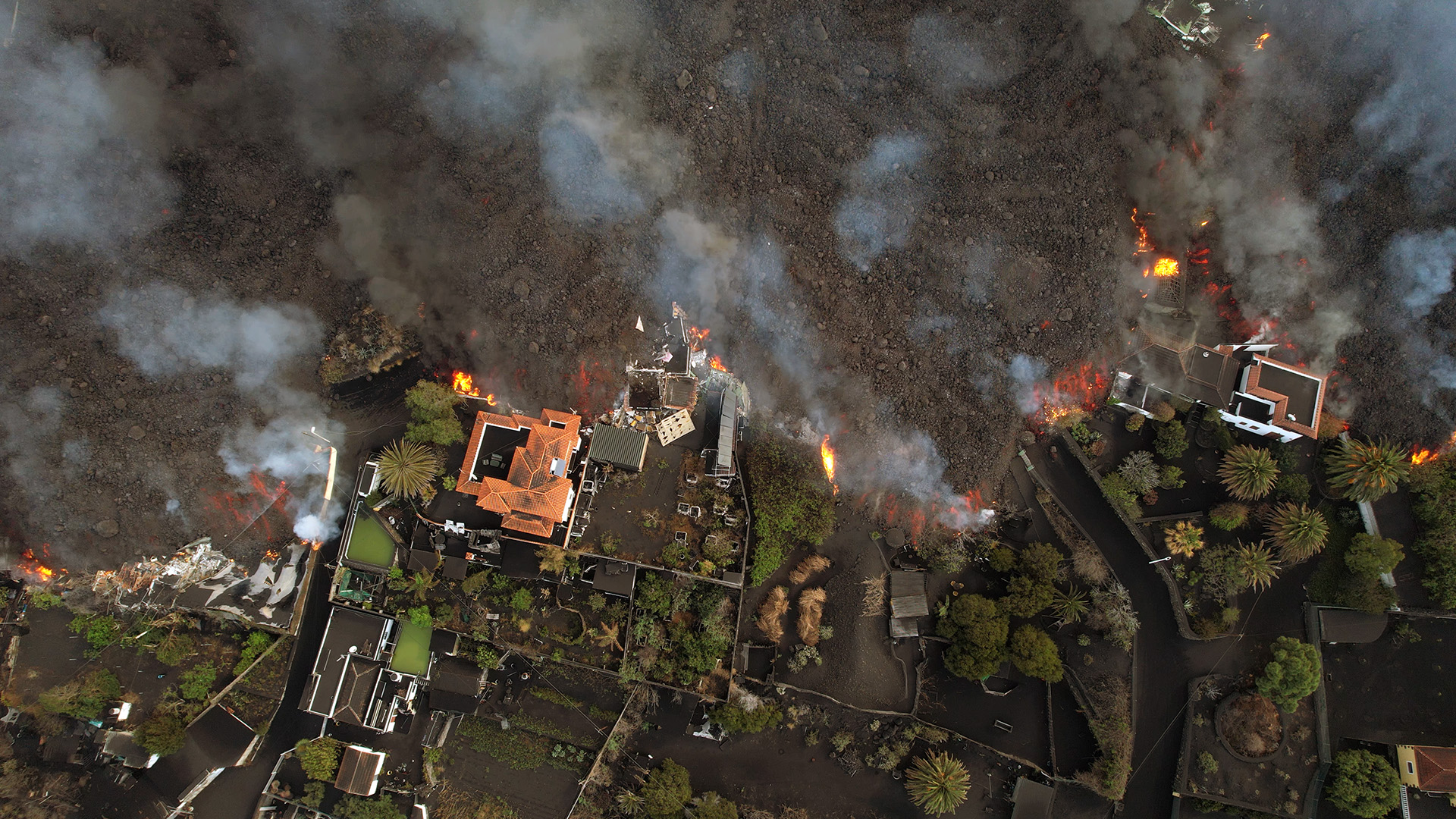 An aerial view of lava advancing and burning houses. This is from Canary Islands: Born of Fire. [Photo of the day - January 2023]
