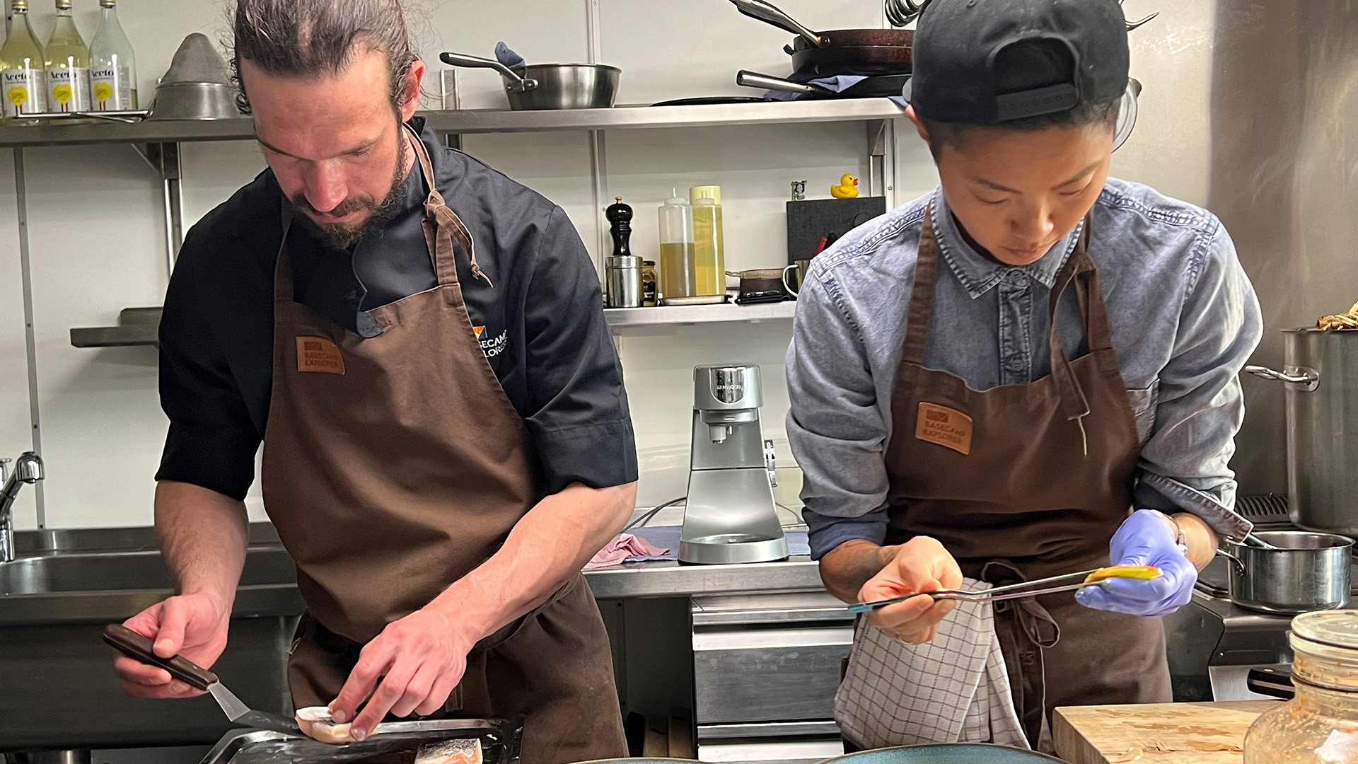 Chefs Kristen Kish and Rogier Jensen plate a dish in the kitchen at Isfjord Radio in Svalbard,... [Photo of the day - April 2023]