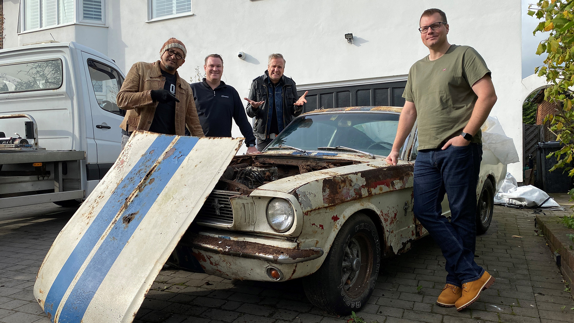 Fuzz Townshend (l to r), John Junior, Tim Shaw and Floyd stand next to the Ford Mustang.  This... [Photo of the day - May 2023]