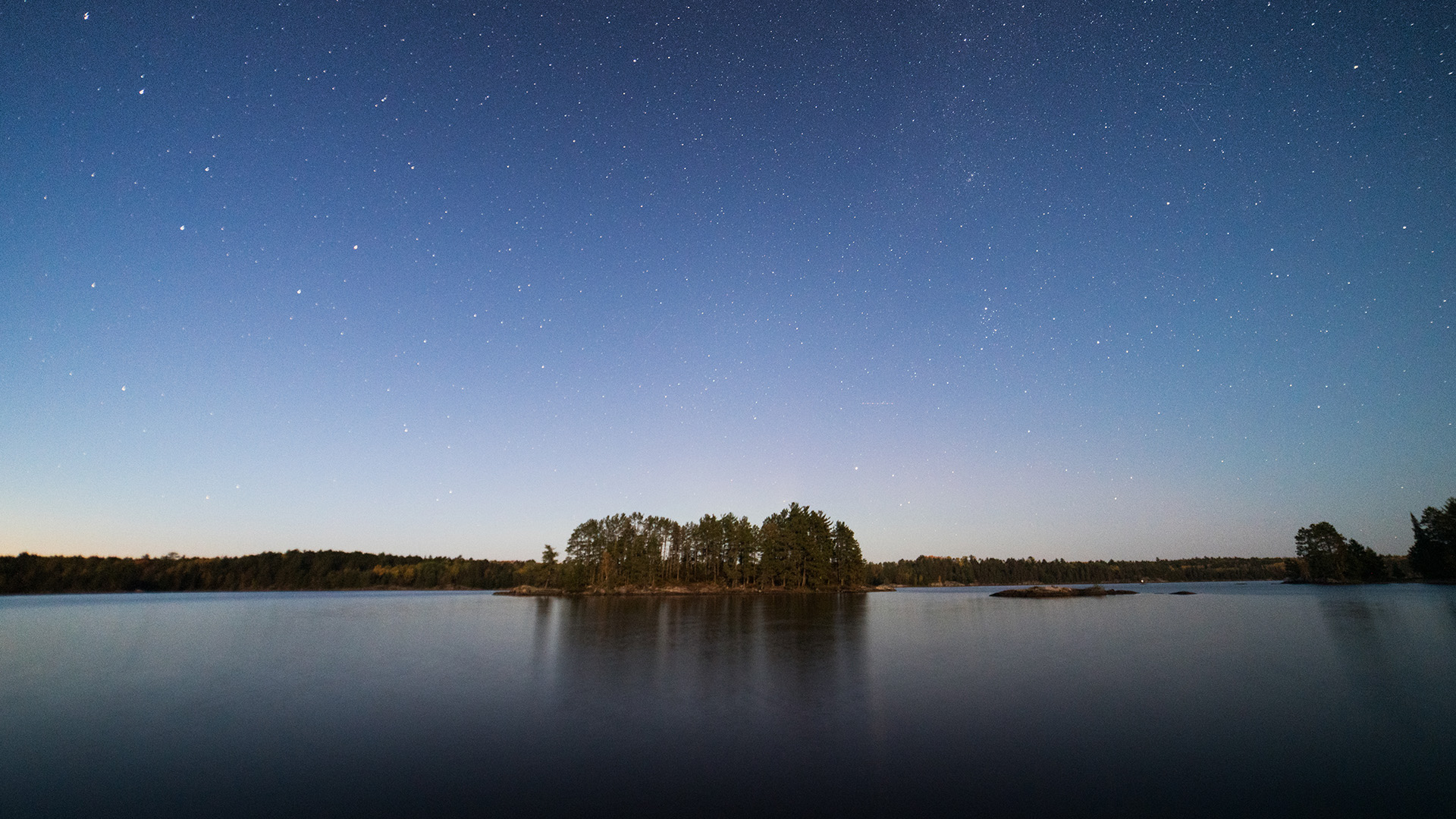 Stars over a lake in Voyageurs National Park. This is from America's National Parks. [Photo of the day - June 2023]
