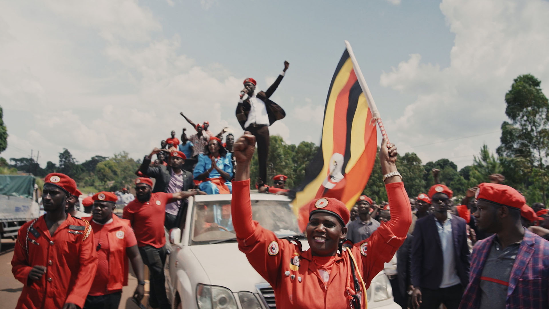 Bobi Wine standing on top of a car at a rally. This is from Bibo Wine: The People's President. [Photo of the day - October 2023]