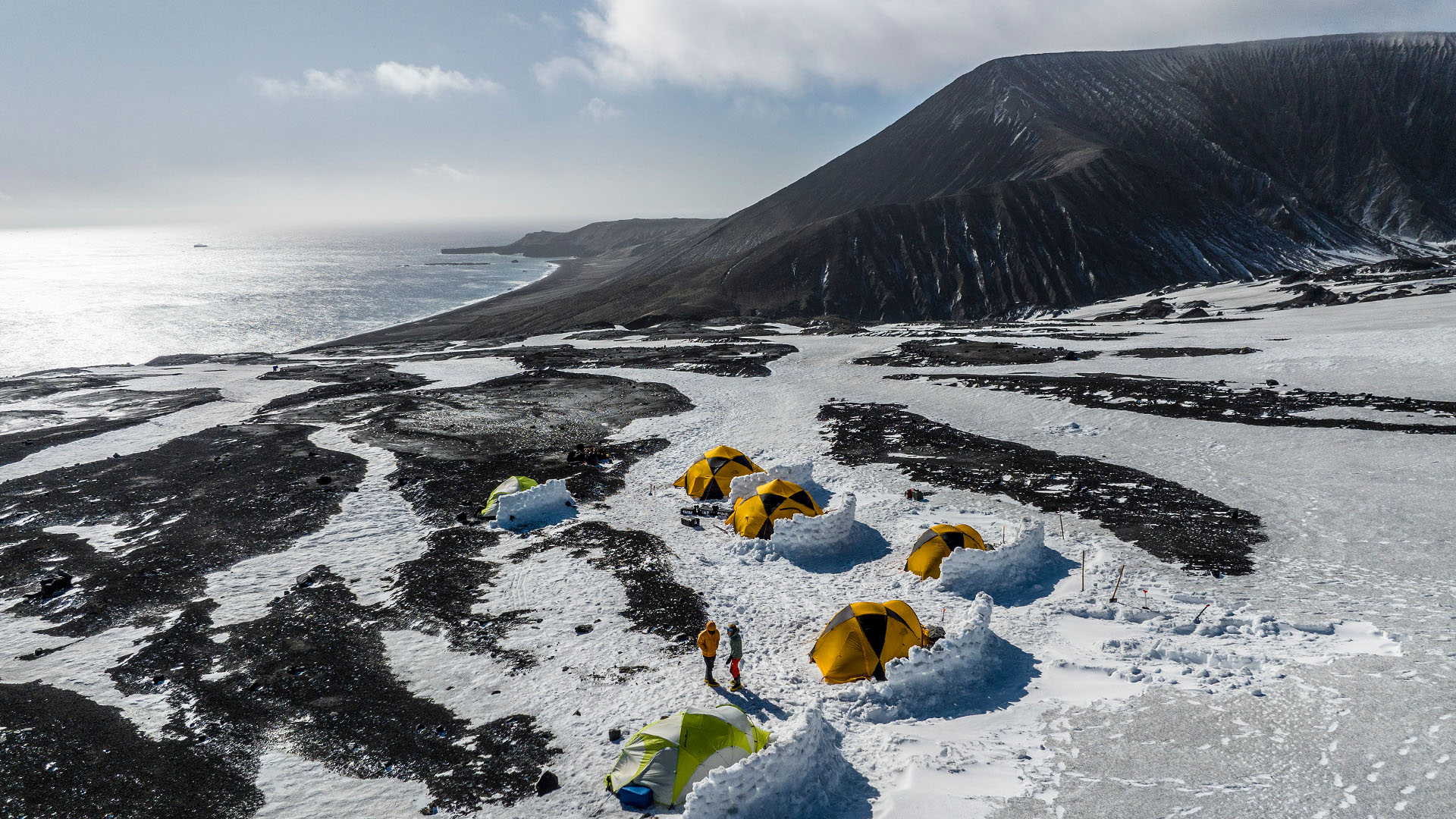 Members of the expedition team stand in base camp on Saunders Island, South Sandwich Islands.... [Photo of the day - October 2023]