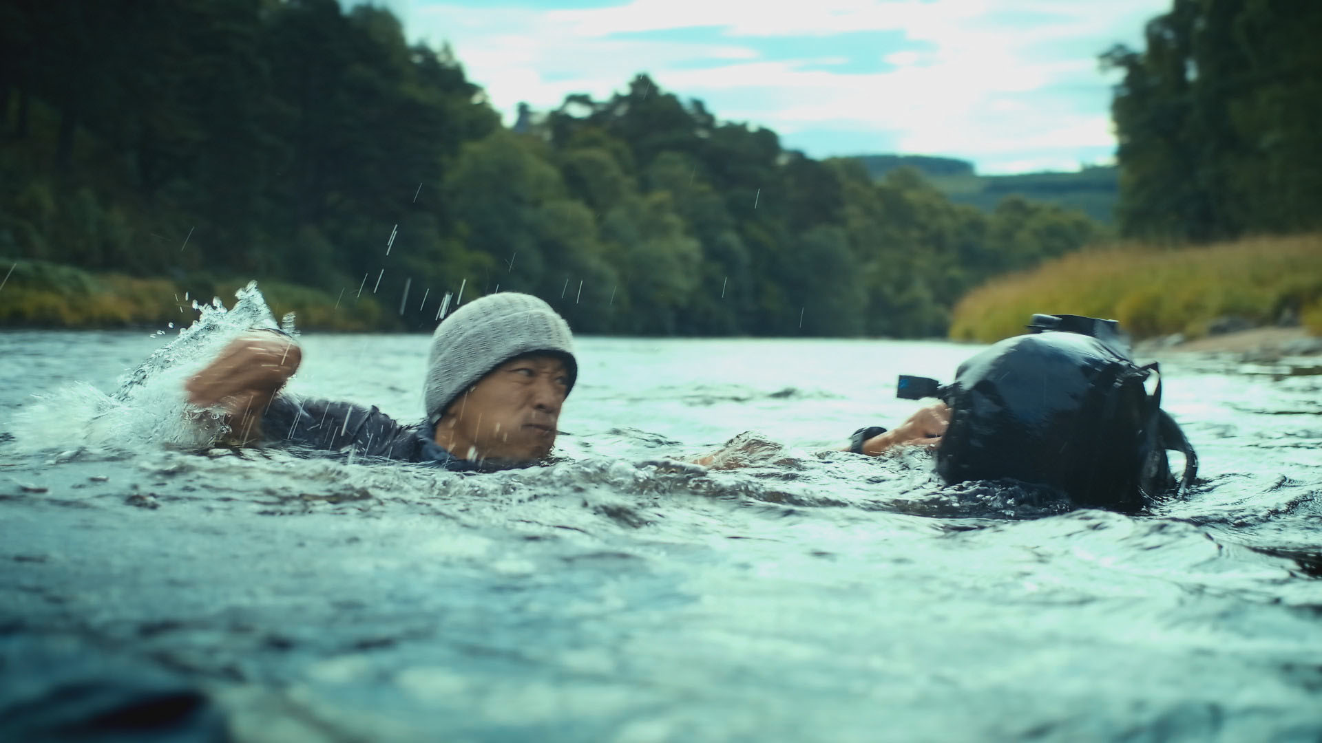 Albert Lin crosses the River Spey carrying a Go-Pro attached to his backpack, as he searches for... [Photo of the day - December 2023]