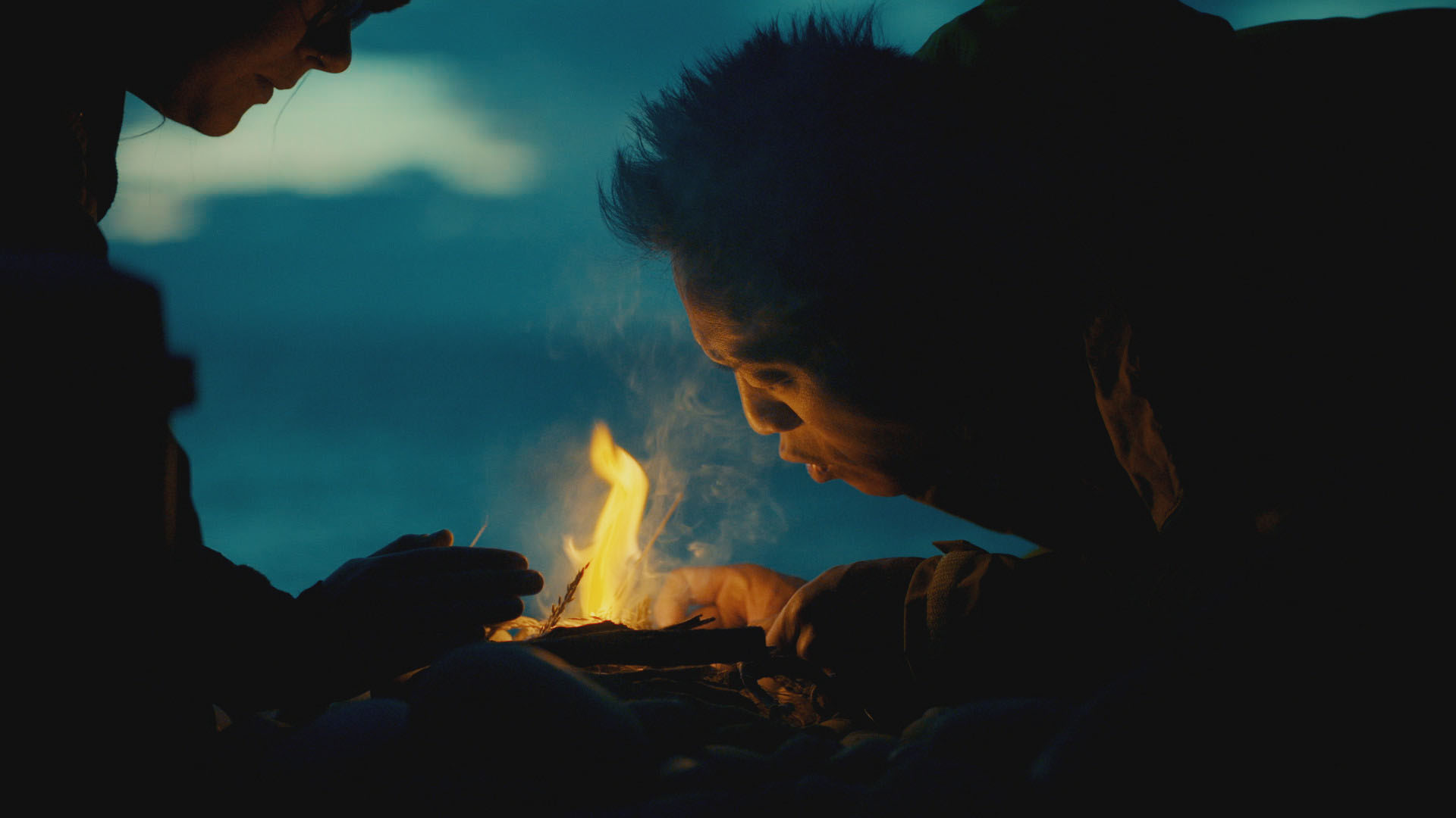 Albert Lin and Lindsey build a fire at dusk outside Sculptor's Cave, Elgin, Scotland, as they... [Photo of the day - December 2023]