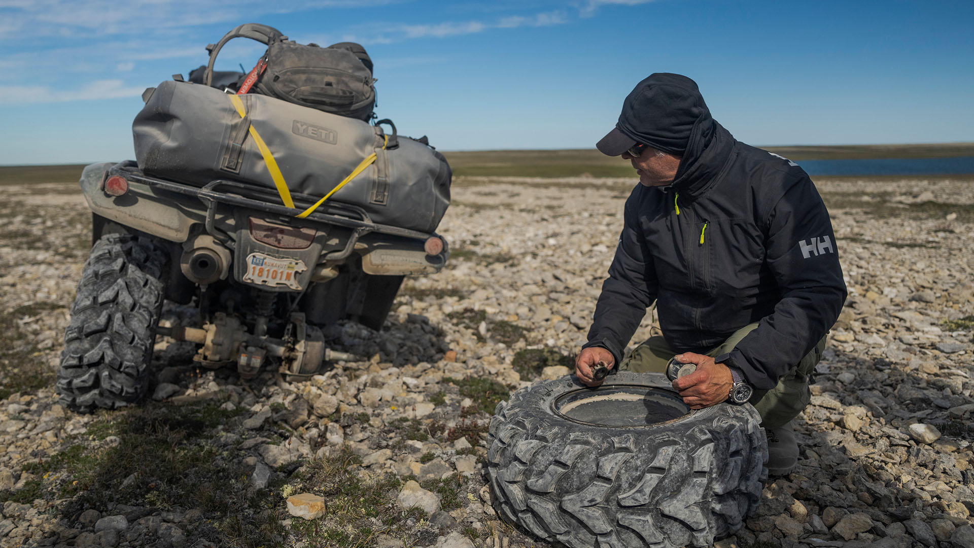 Franklin historian Tom Gross fixes a broken tire on one of the ATVs during the journey in search... [Photo of the day - December 2023]