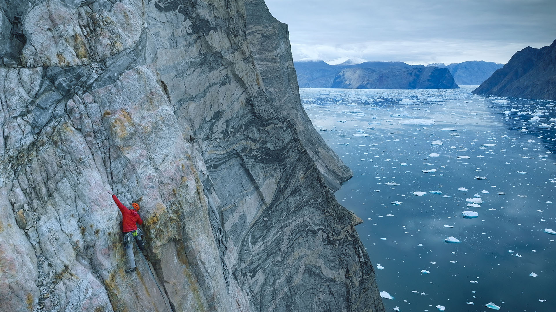 Alex Honnold climbs with mountains and water in the background. This is from Arctic Ascent with... [Photo of the day - February 2024]