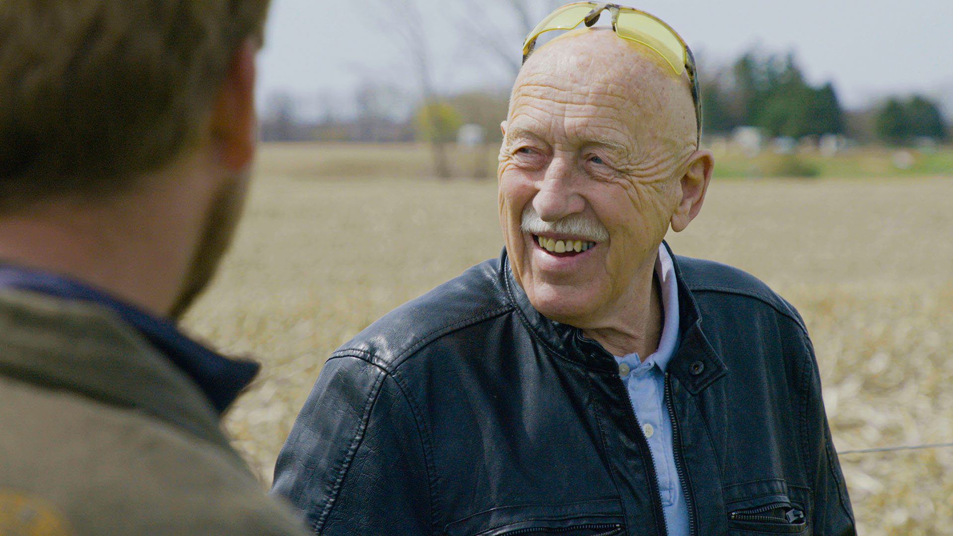 Dr. Jan Pol smiles in the hayfield at the Pol Family Farm as he talks with Charles Pol and Ben... [Photo of the day - أبريل 2024]