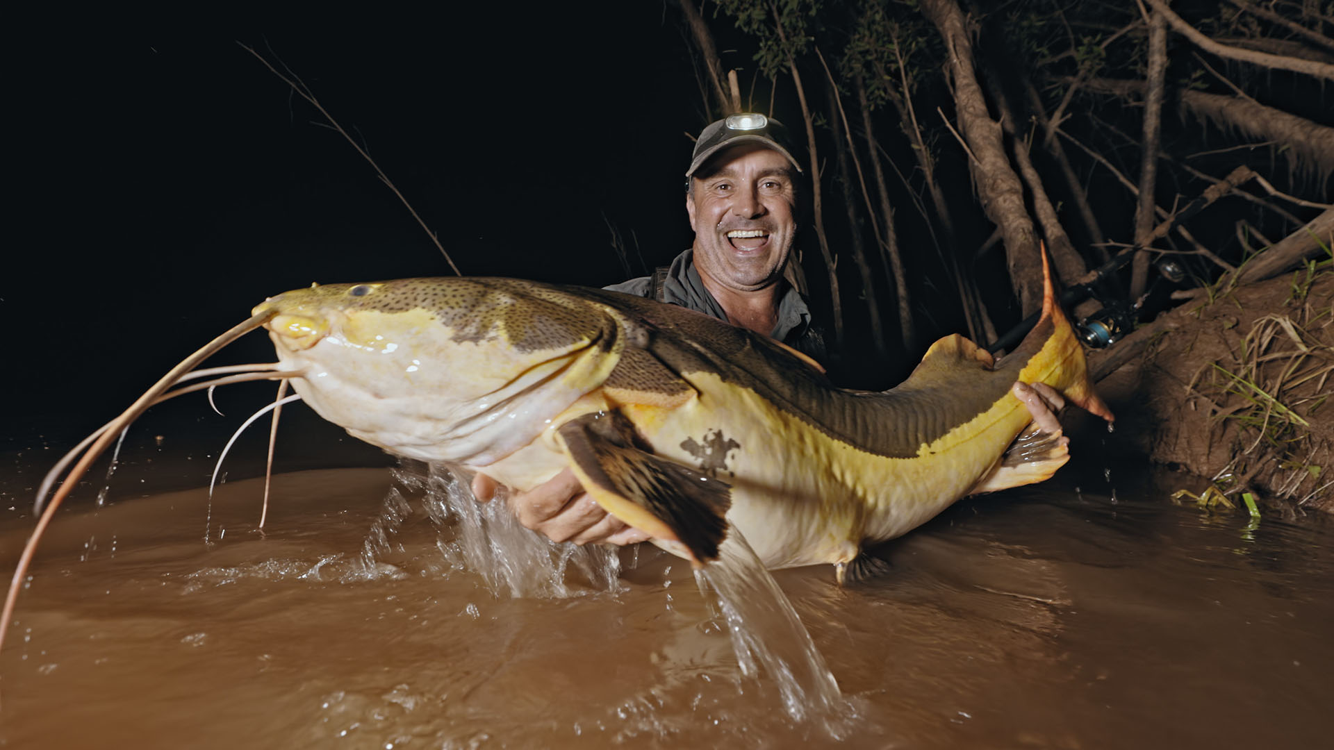 Cyril holds a massive redtail catfish waist-deep in Bolivia at night. This is from Last of the... [Photo of the day - May 2024]