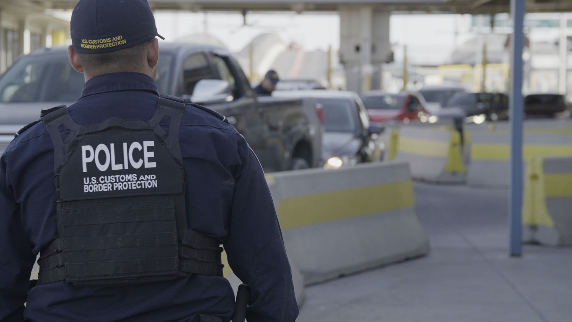 A CBP officer looks at the multiple lines of vehicles that are waiting to cross the border at... [Photo of the day - May 2024]
