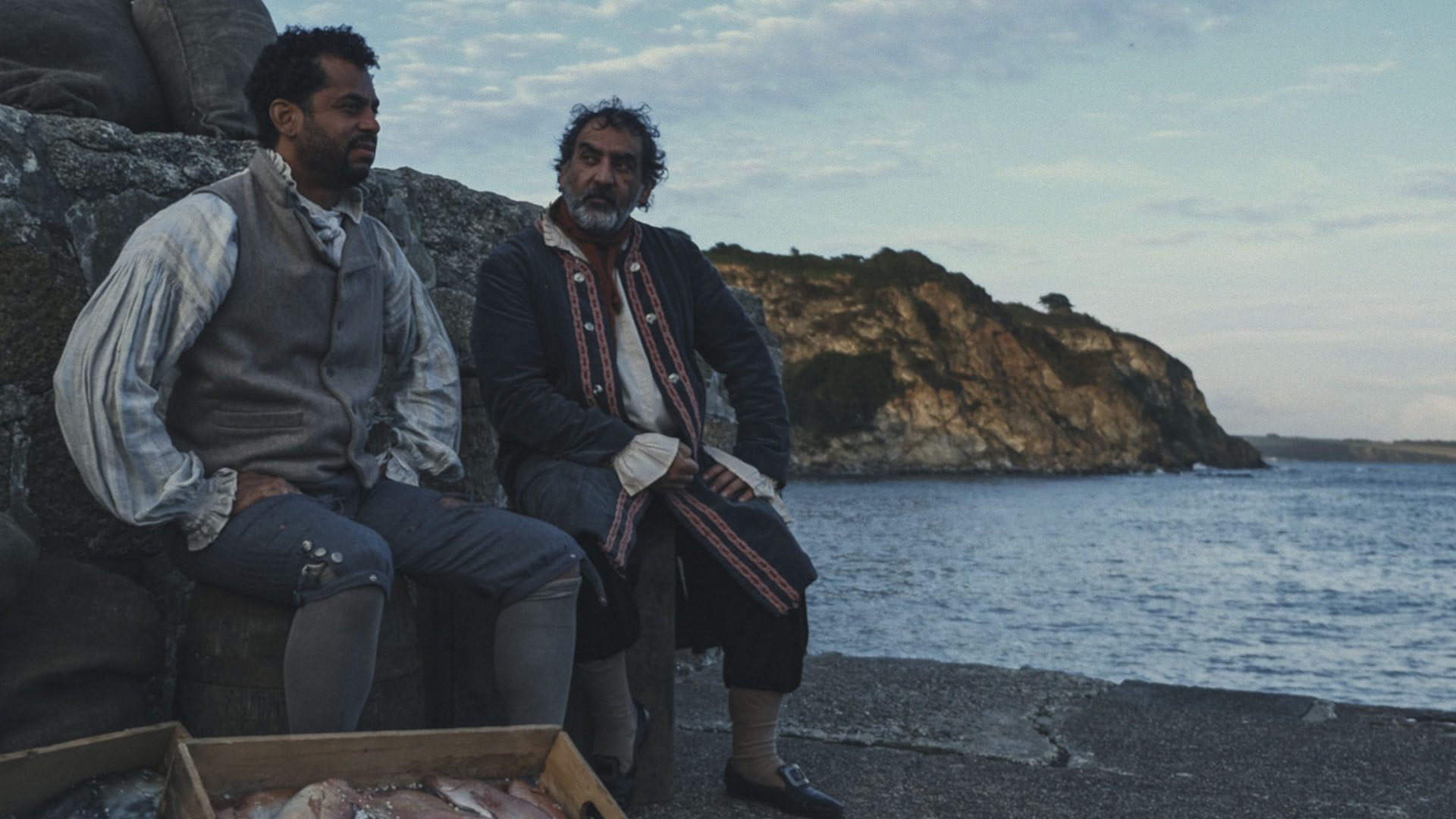 REENACTMENT - Two pirates sit on the beach with crates of fish. This is from Pirates: Behind the... [Photo of the day - August 2024]