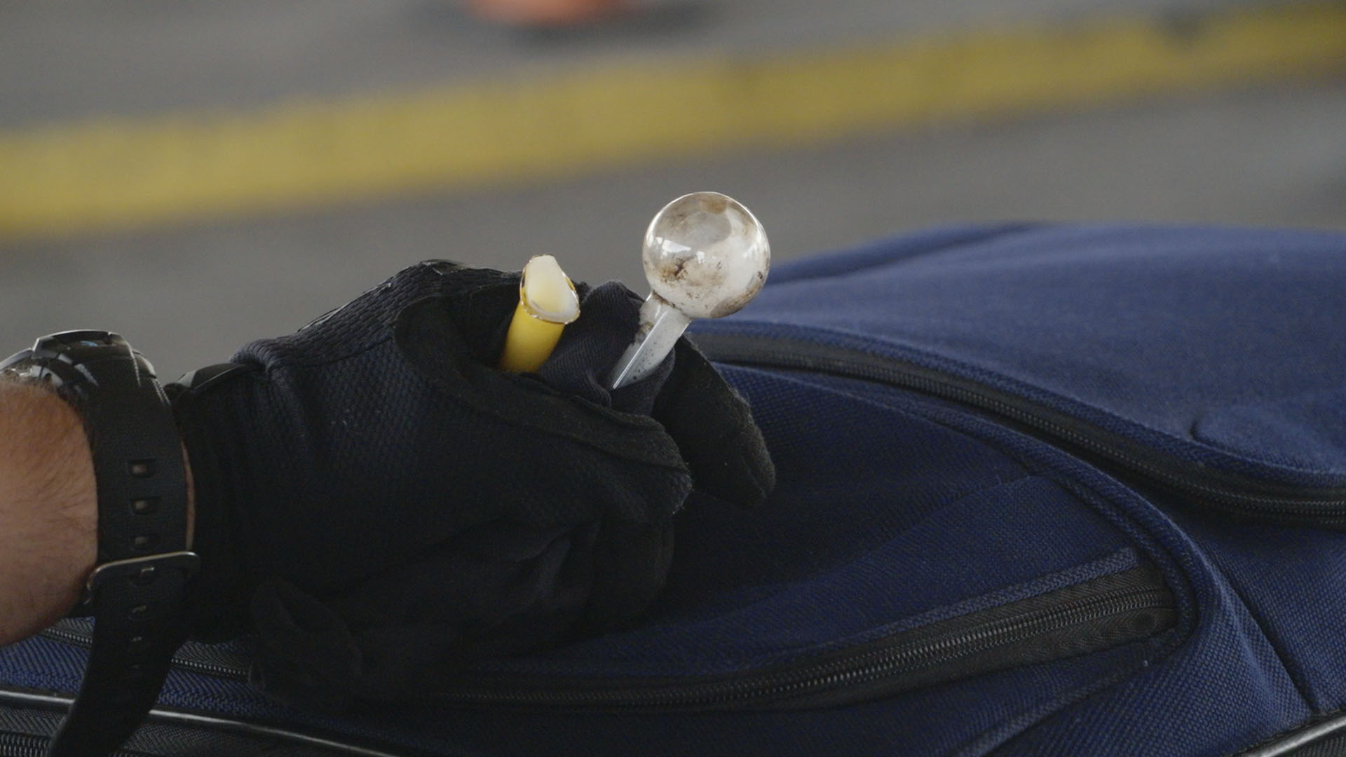 A CBP officer holds drug paraphernalia found among a passenger's belongings in El Paso. Texas.... [Photo of the day - September 2024]