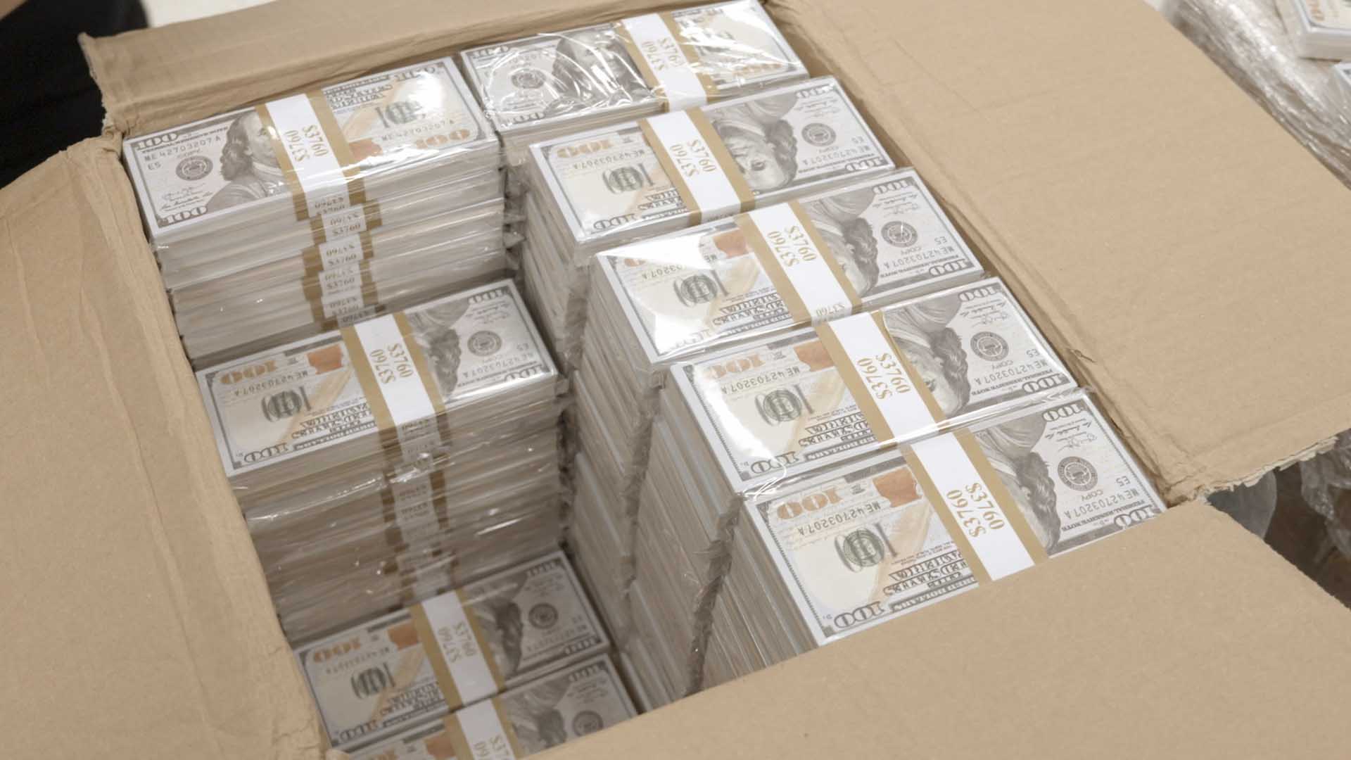 CBP Officers Pirollo and Johnson open and inspect stacks of counterfeit currency they discovered... [Photo of the day - October 2024]