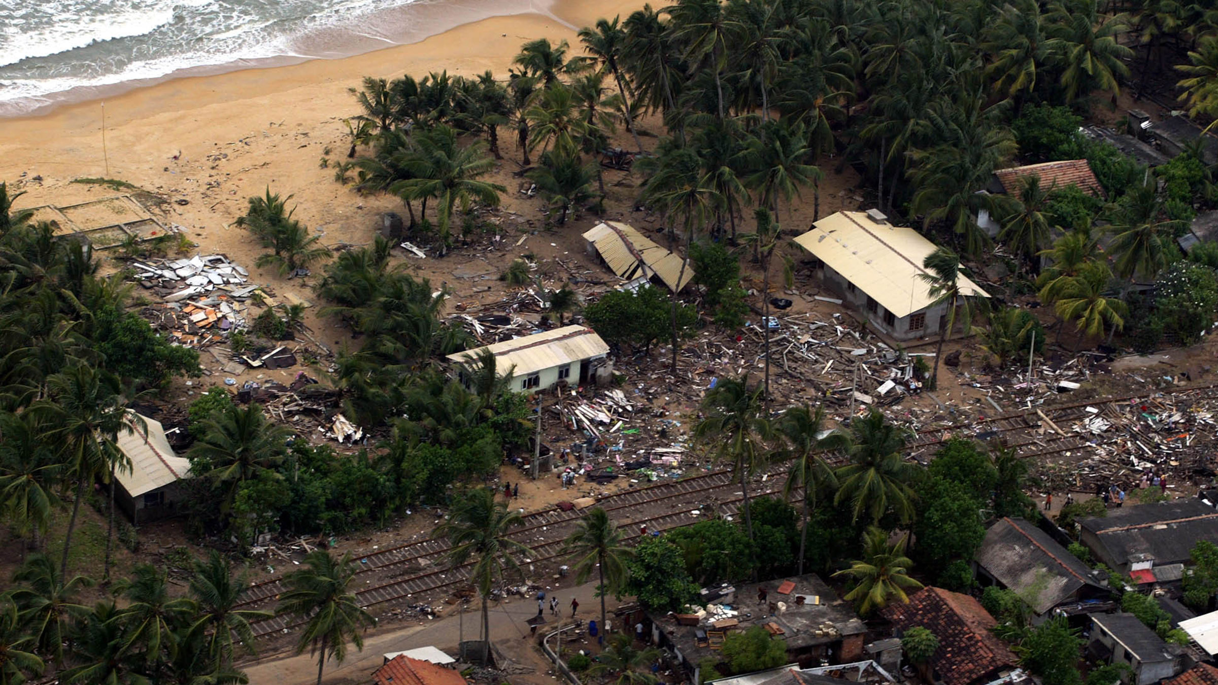 Destroyed houses and scattered debris are seen from above after the tsunami hit Sri Lanka's west... [Photo of the day - ديسمبر 2024]