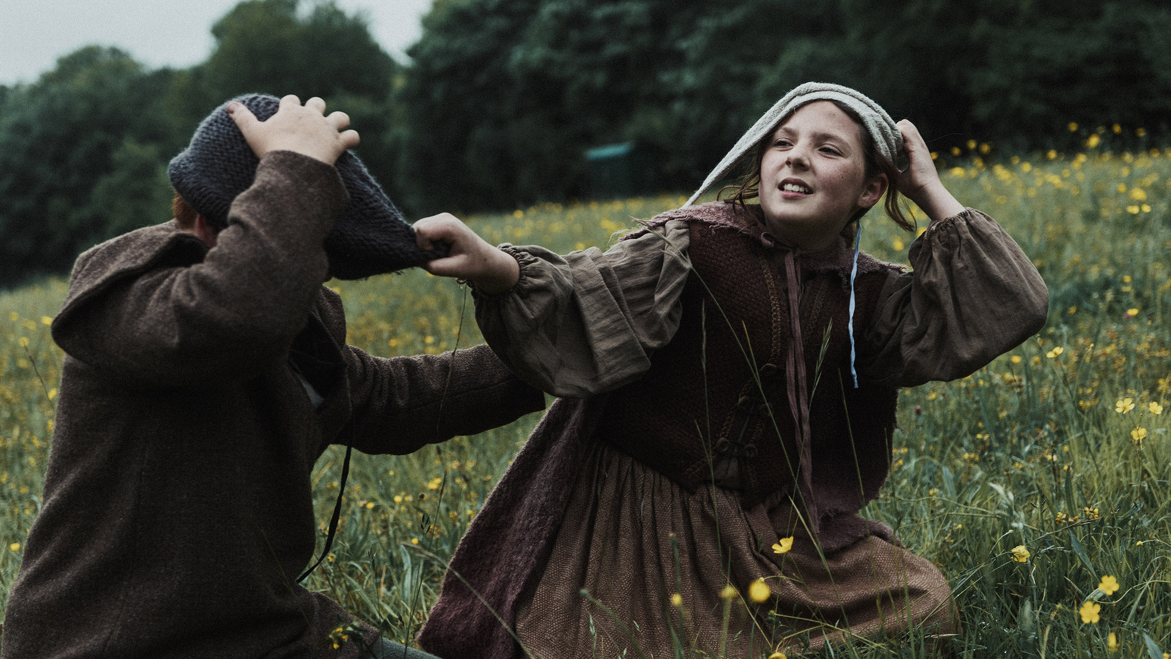 Gertrude, a young girl, tugs on the woolen cap of Mats, her young companion. This is from... [Photo of the day - December 2024]