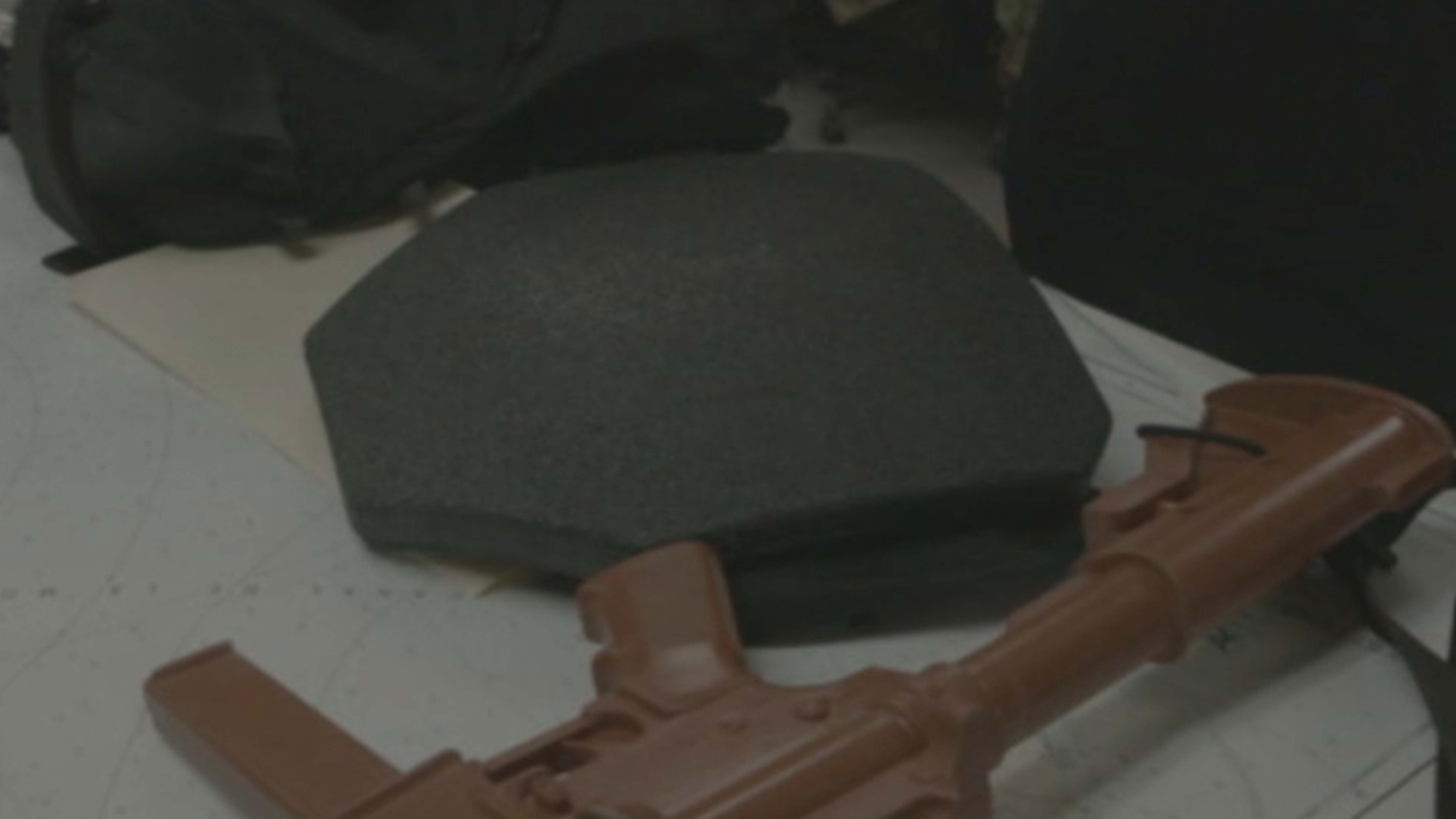 Padding for a bulletproof vest and a firearm are pictured on a table, ready to be used by agents... [Photo of the day - January 2025]