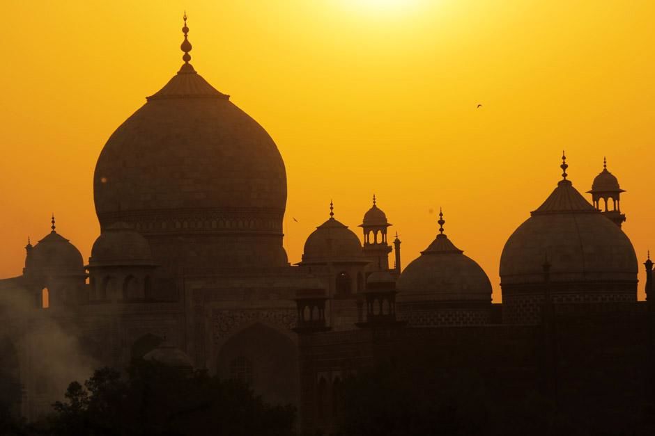Agra, India: The magnicifent view of Taj Mahal with a yellow sky background as the sun calmly... [Photo of the day - January 2013]