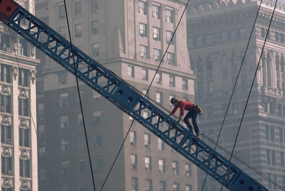 A construction worker climbs up a crane near tall buildings in Pittsburgh, Pennsylvania. USA. [Photo of the day - November 2011]