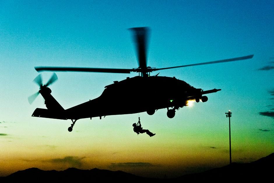 Kandahar Airfield, Afghanistan: A PJ hoists down from a HH-60G Pave Hawk helicopter at dusk.... [Photo of the day - June 2013]