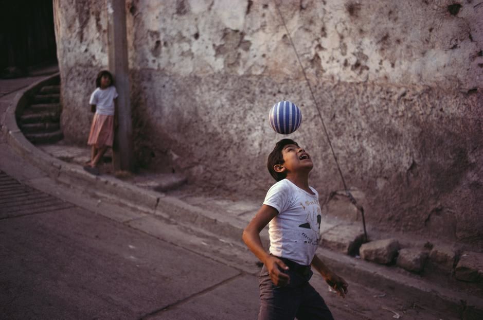 A young girl watches a boy demonstrate his soccer skills in Tegucigalpa. Honduras. [Photo of the day - November 2011]