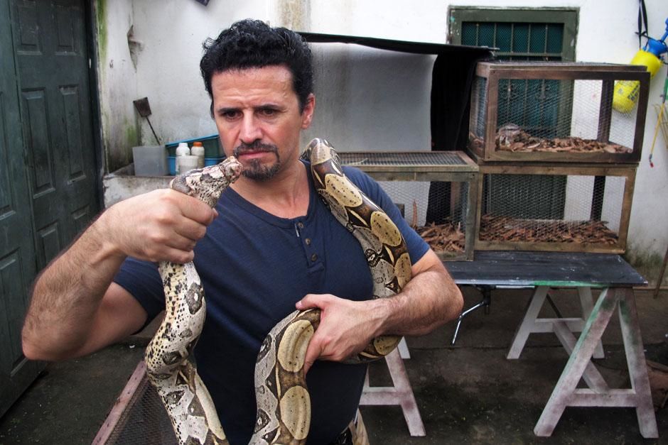 Belize: Reenactment. Tom with a snake aroud his neck. This image is from Banged Up Abroad. [Photo of the day - July 2013]