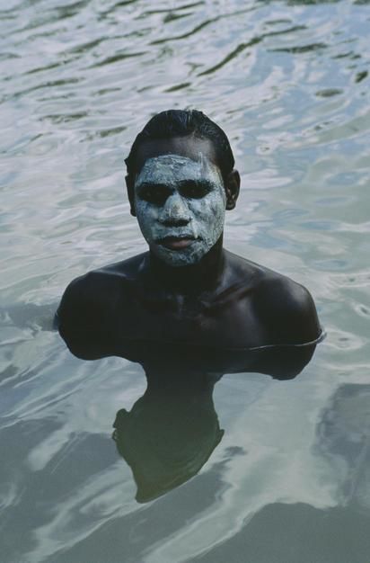 Aboriginal teen with a mask of mud, swiming in a billabong, Cape York Peninsula, Queensland. [Photo of the day - January 2012]