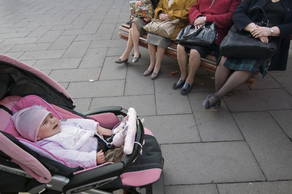 Elderly ladies sitting on a bench looking at a baby in Venice. [Photo of the day - January 2012]