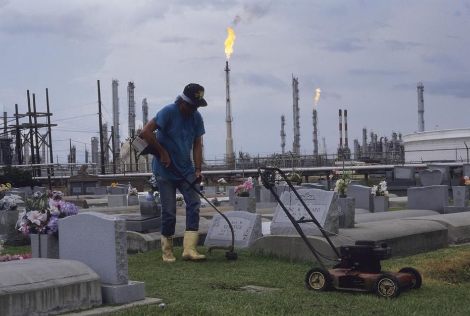 A man cuts the grass at a cemetary in an area known as Cancer Alley in Morrisonville, Louisiana. [Photo of the day - February 2011]