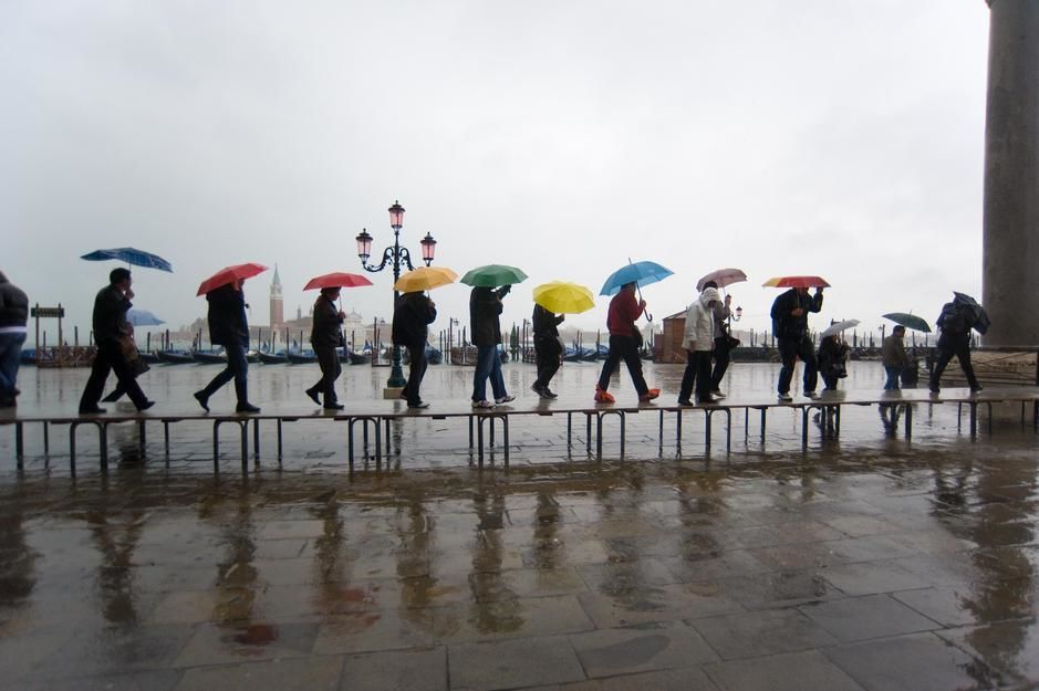 Pedestrians on an elevated walkway at high tide in Piazza San Marco, Venice. [Photo of the day - مارس 2011]