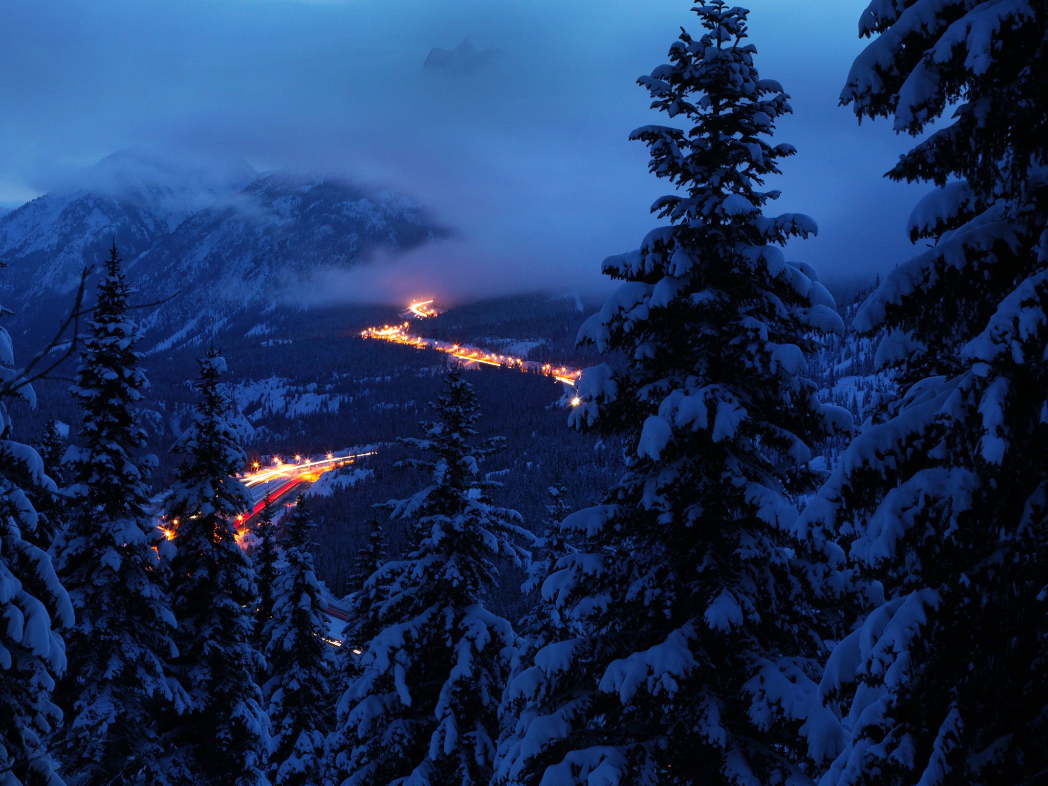 Snow-filled mountain, trees, and highway from lookout point. This image is from Highway Thru Hell. [Photo of the day - October 2014]