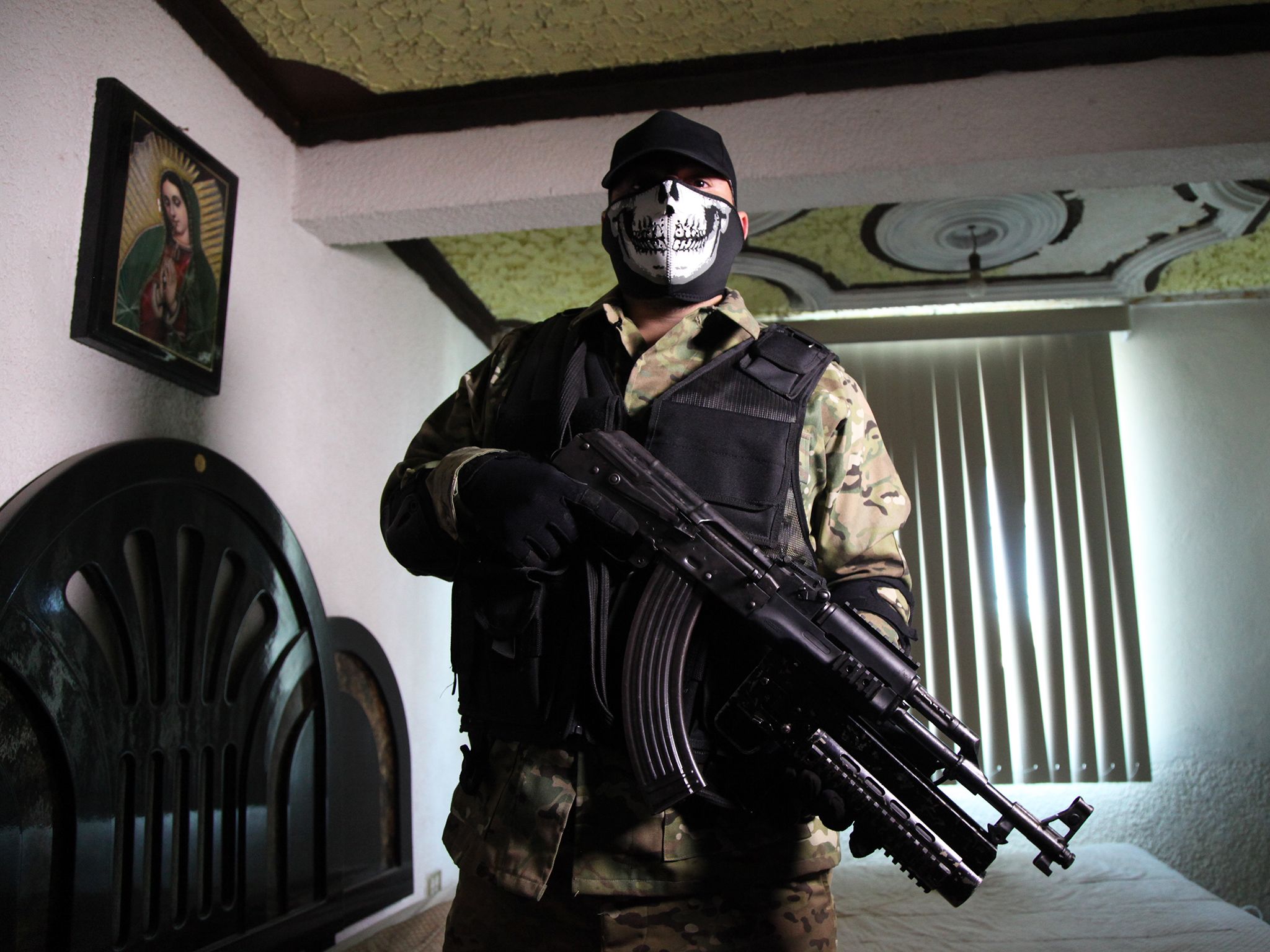 Mexico: 'Commander X' cartel hitman poses with his AK 47 before he heads out to protect his... [Photo of the day - January 2015]