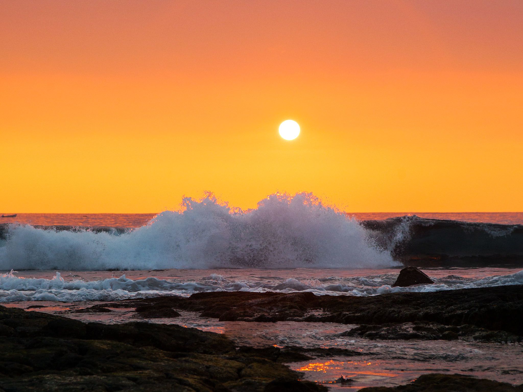 Tide rolls in at Sunset onto the rocky Kona shores. This image is from United Sharks of America. [Photo of the day - August 2015]
