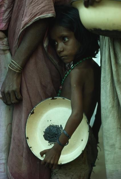 A girl waits for relief food. [Photo of the day - May 2011]