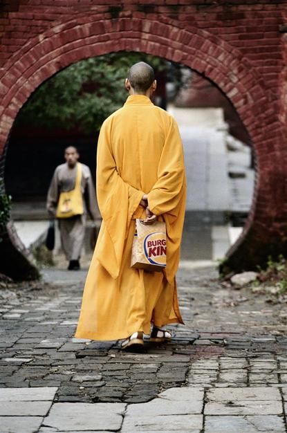 A monk at the Shaolin temple in Henan Province walks with a Burger King bag. [Photo of the day - June 2011]