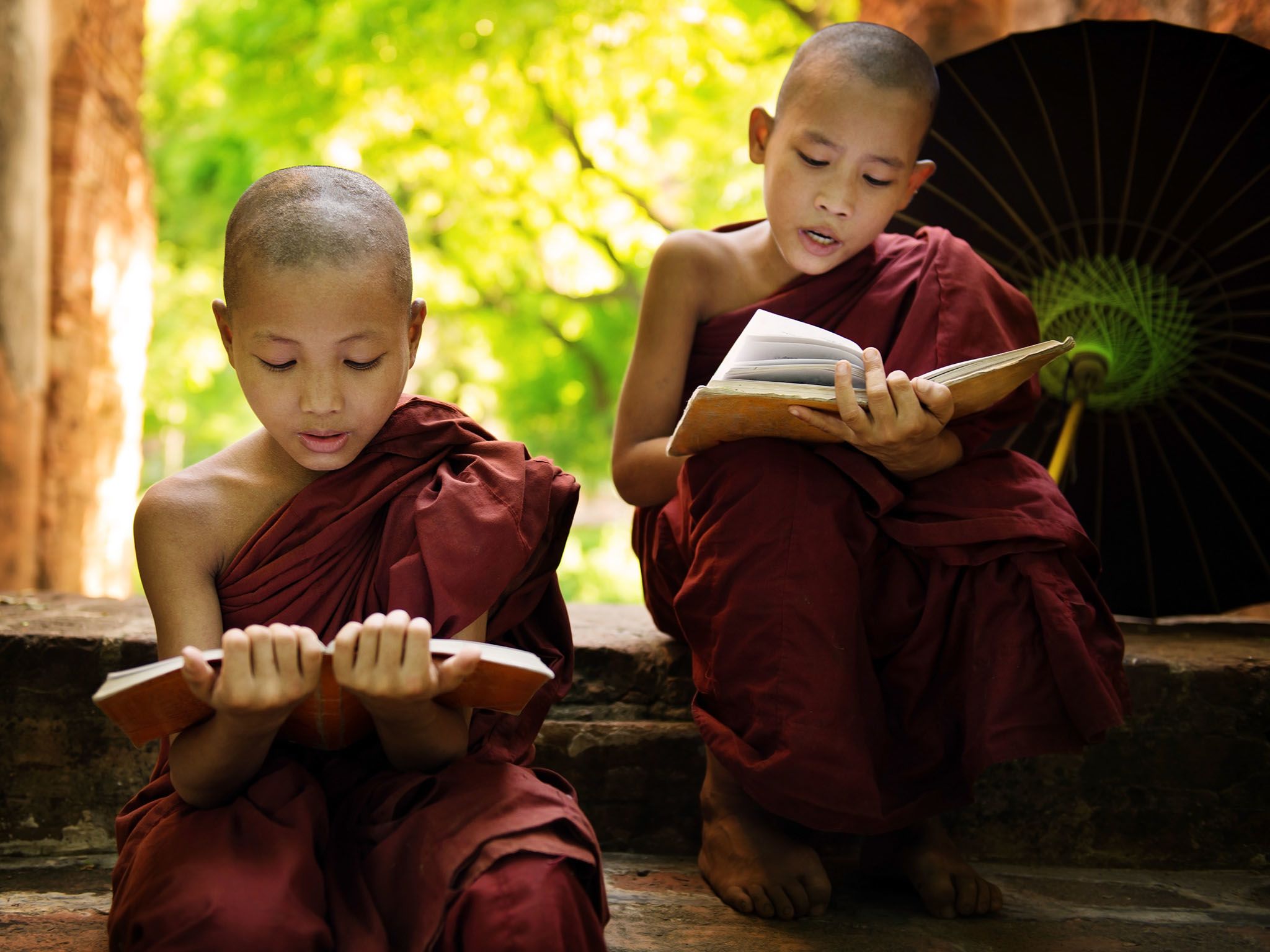 Southeast Asian Myanmar little monk reading book outside monastery, Buddhist teaching. This... [Photo of the day - April 2016]