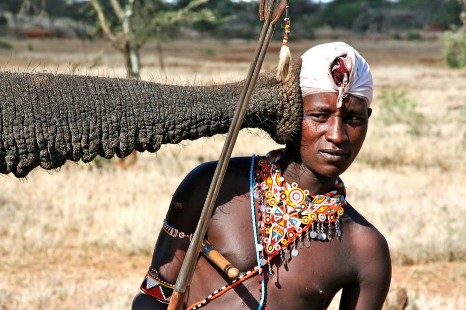 Kenya: Maasai warrior Boni listens up close to an African elephant. This image is from Warrior... [Photo of the day - March 2012]