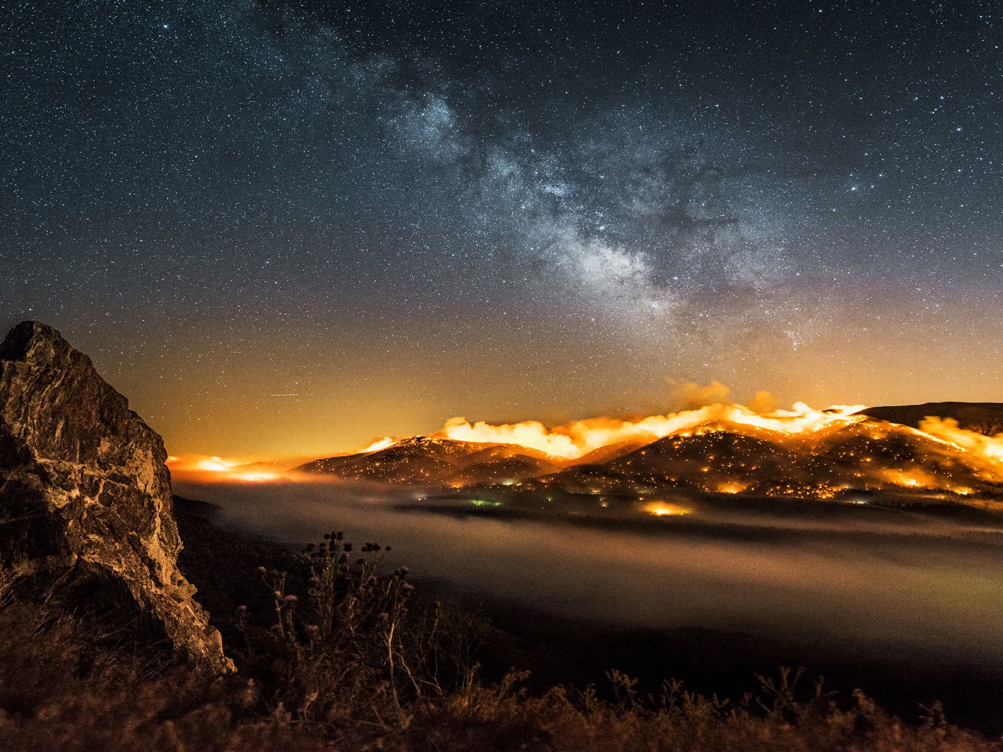 Time-lapse burning hillside with Milky way above.  This image is from One Strange Rock. [Photo of the day - March 2018]