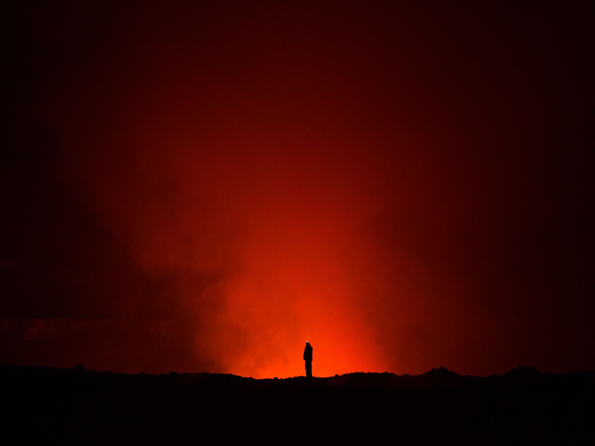 Prof. Ken Sims of the University of Wyoming looking over a lava crater at Mount Nyiragongo. Lava... [Photo of the day - March 2018]