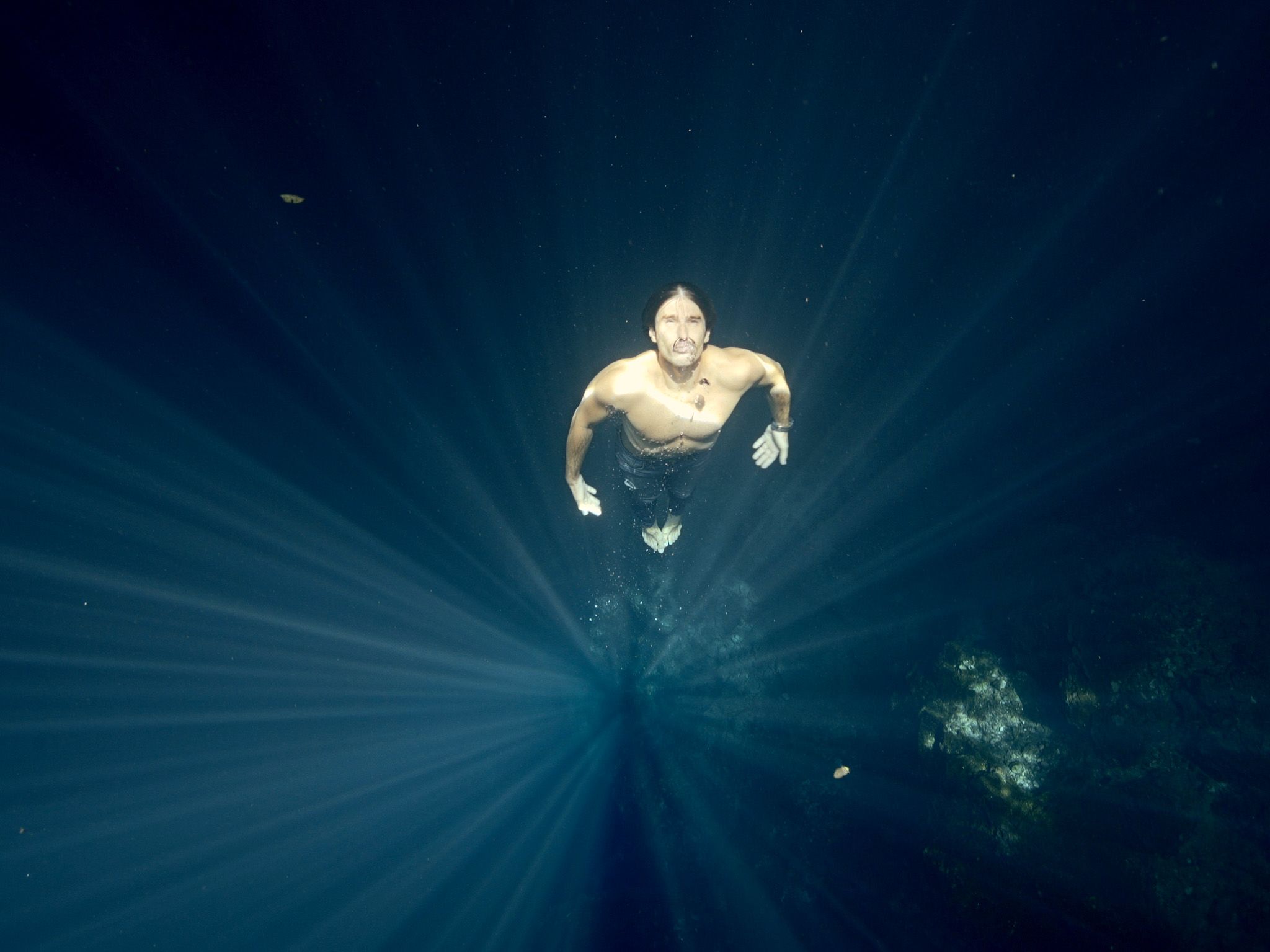 Free diver coming to the surface in a ray of sunshine.  This image is from One Strange Rock. [Photo of the day - March 2018]